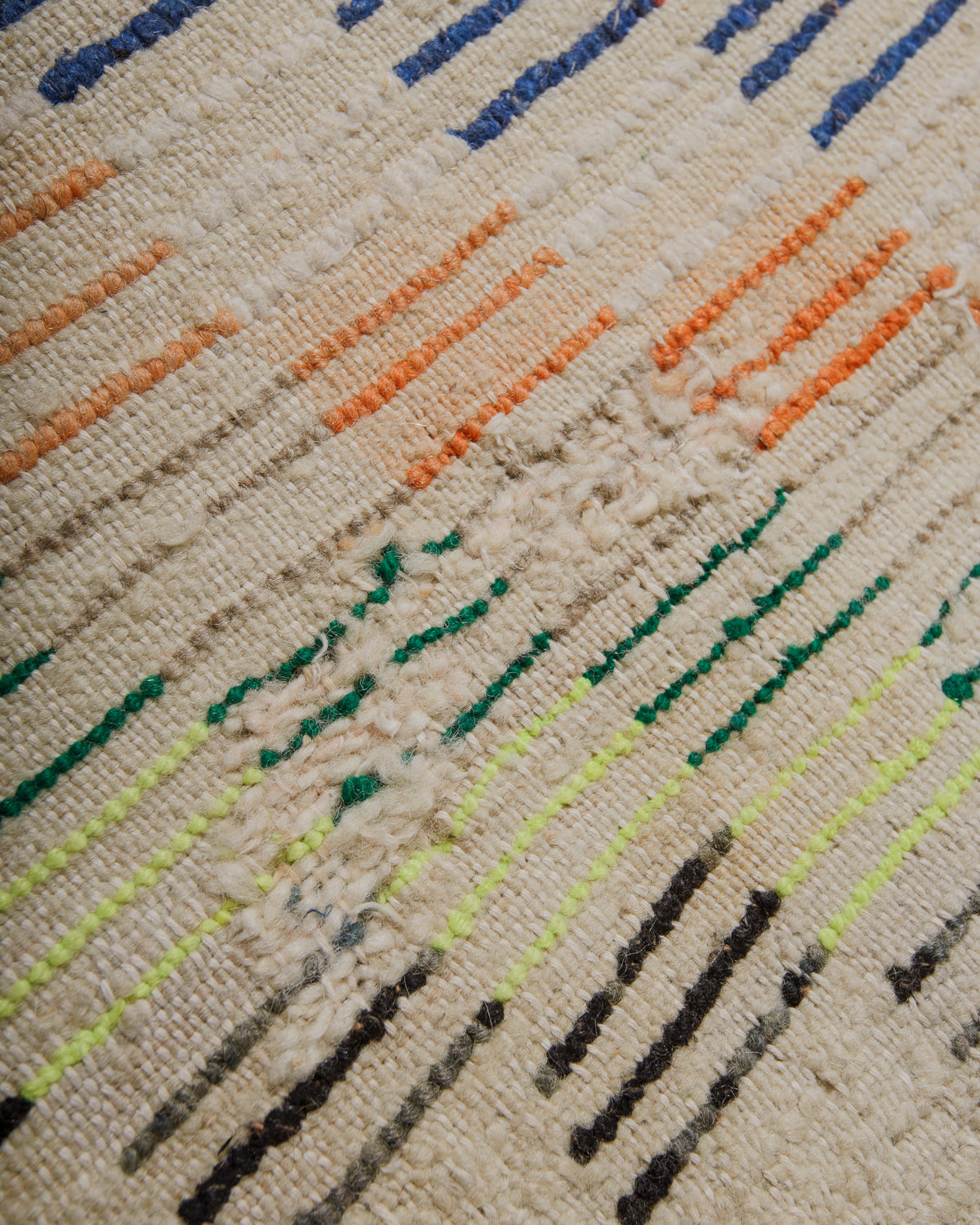 Back of rug showing repaired patches.